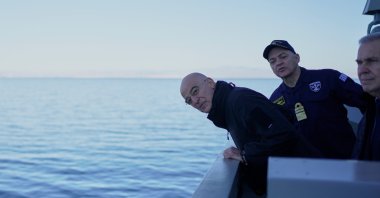 Greek Defense Minister Nikos Dendias looks at the sea as he attends a welcoming ceremony aboard the frigate Kimon, near Athens, Greece, Jan. 15, 2026. (AP Photo)