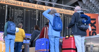 Passengers look at the announcement board showing canceled flights at Frankfurt Airport in Frankfurt am Main, Germany, April 10, 2026. (AFP Photo)