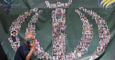 A man walks past a banner installed along the roadside in Tehran, Iran, April 29, 2026. (AFP Photo)