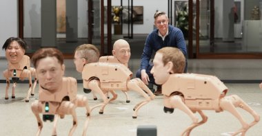 Artist Beeple, Mike Winkelmann, poses inside his installation titled Regular Animals, with robots in the likeness of Kim Jong Un (L) Elon Musk (2nd L), Jeff Bezos (C) and mark Zuckerberg (R) at the Neue Nationalgalerie museum, Berlin, Germany, April 28, 2026. (AP Photo)