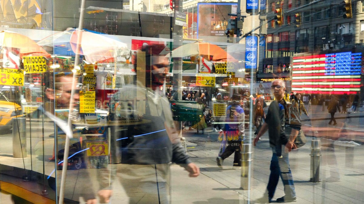 People are reflected in a shop window at Times Square in the Manhattan borough of New York, U.S., April 24, 2026. (AFP Photo)