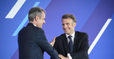 Greek Prime Minister Kyriakos Mitsotakis (L) shakes hands with French President Emmanuel Macron during a Franco-Greek Economic Forum in Athens, Greece, April 25, 2026. (AFP Photo)