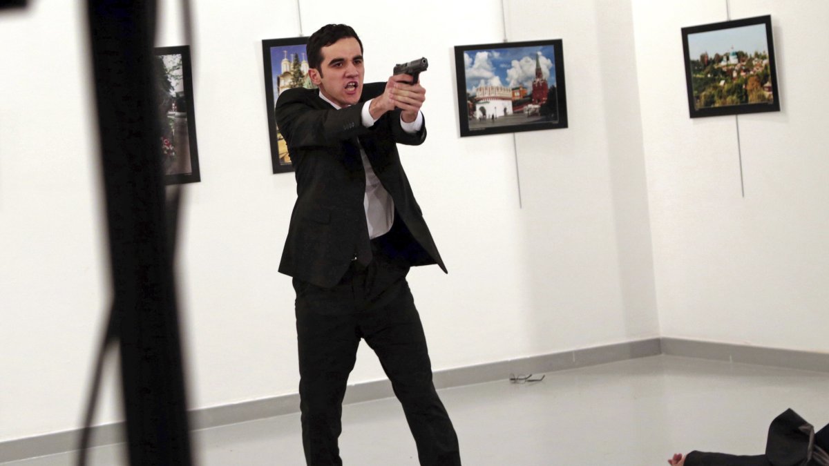 Mevlüt Mert Altıntaş, an off-duty policeman, shouts after shooting Andrei Karlov, the Russian ambassador to Türkiye, at an art gallery, Ankara, Türkiye, Dec. 19, 2016. (AP Photo)
