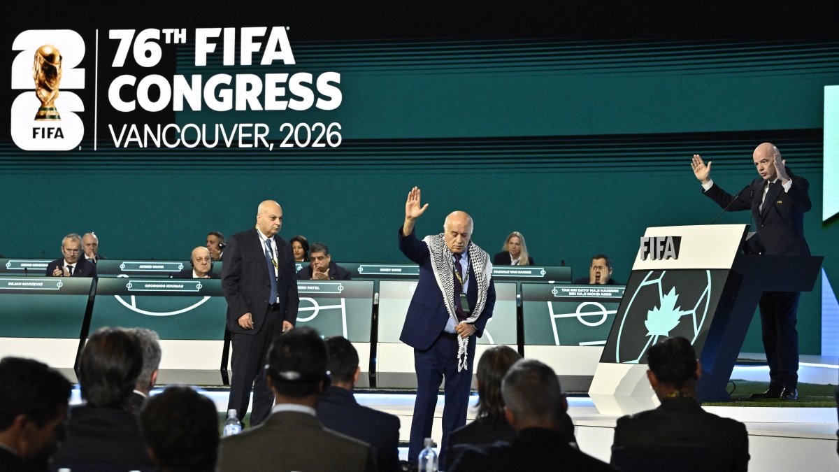 Palestine Football Association President Jibril Rajoub (C) reacts on stage as Israeli Football Federation President Moshe Zuares (C) and FIFA President Gianni Infantino look on during the 76th FIFA Congress at the Vancouver Convention Centre, Vancouver, Canada, April 30, 2026. (Reuters Photo) 