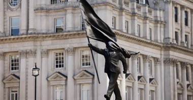 A statue depicting a person stepping off the plinth while carrying a flag covering their face, by British street artist Banksy, stands in London, U.K., April 30, 2026. (Reuters Photo)
