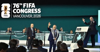 Palestine Football Association President Jibril Rajoub (C) reacts on stage as Israeli Football Federation President Moshe Zuares (C) and FIFA President Gianni Infantino look on during the 76th FIFA Congress at the Vancouver Convention Centre, Vancouver, Canada, April 30, 2026. (Reuters Photo) 