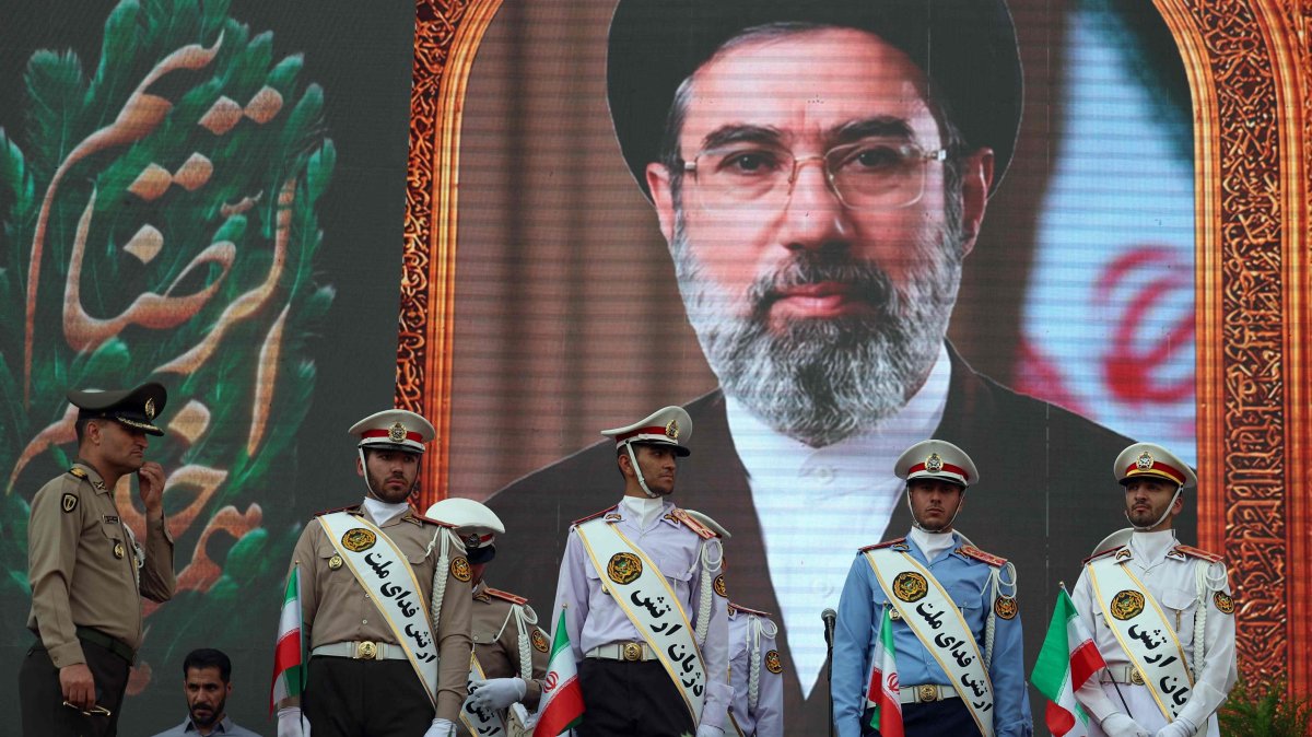 Iranian army soldiers stand in front of a picture of Iran's supreme leader Ayatollah Mojataba Khamenei during a rally to show their solidarity and support to the new Iranian supreme leader Ayatollah Mojataba Khamenei in Tehran, Iran, April 29, 2026. (AFP Photo)