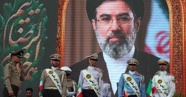 Iranian army soldiers stand in front of a picture of Iran's supreme leader Ayatollah Mojataba Khamenei during a rally to show their solidarity and support to the new Iranian supreme leader Ayatollah Mojataba Khamenei in Tehran, Iran, April 29, 2026. (AFP Photo)
