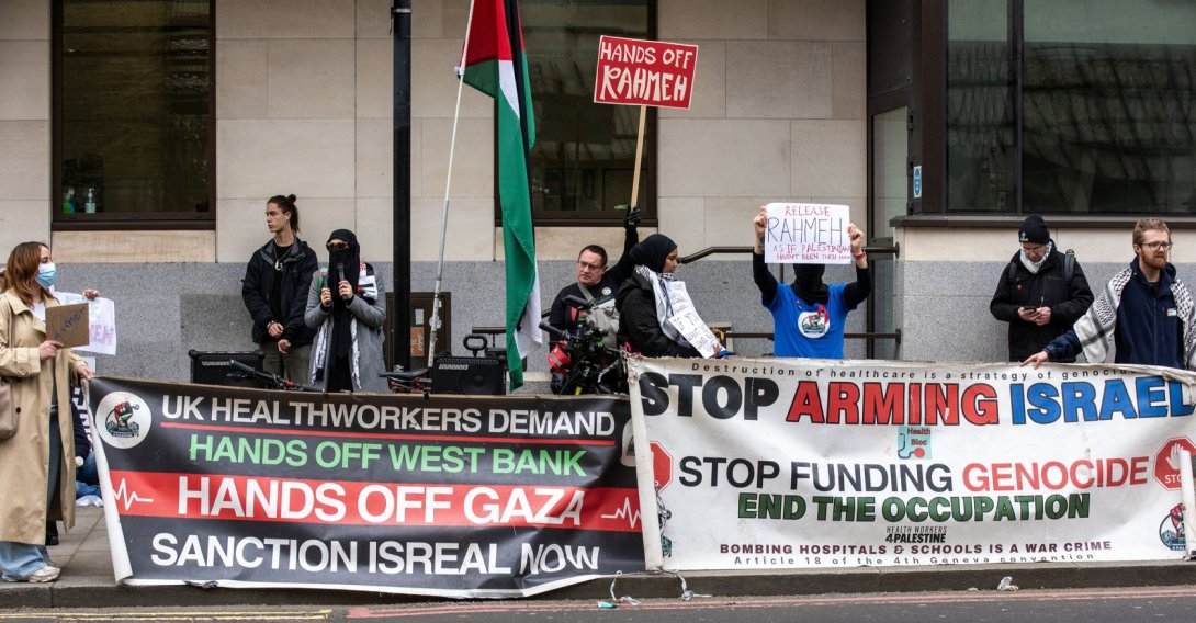 A group of pro-Palestinian protesters hold banners and placards outside the Westminster Magistrates' Court on London, UK, March 27, 2026. (Getty Images Photo)