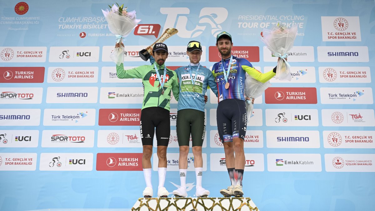 Overall winner of the 61st Presidential Cycling Tour of Türkiye, Sebastian Berwick (C), poses on the podium with second Ivan Ramiro Sosa and Kamiel Bonneu, in Ankara, Türkiye, May 2, 2026. (AA Photo)