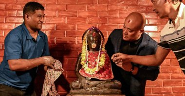 Devotees prepare to reinstall a sculpture of the Buddha at a temple, Kathmandu, Nepal, May 1, 2026. (AFP Photo)