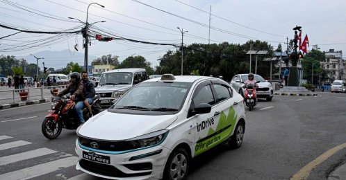 This photograph shows passengers riding an electric inDrive taxi along a street, Kathmandu, Nepal, April 29, 2026. (AFP Photo)