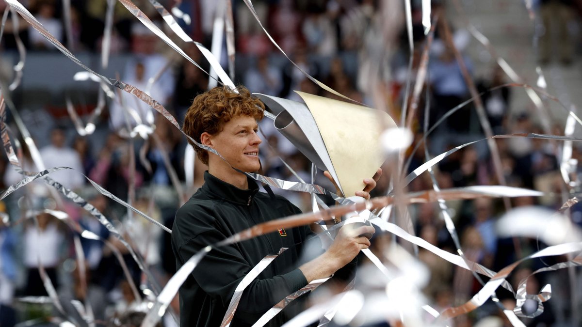 Italy's Jannik Sinner celebrates with his trophy after winning the 2026 ATP Tour Madrid Open tennis tournament final singles match against Germany's Alexander Zverev at the Caja Magica, Madrid, Spain, May 3, 2026. (AFP Photo)