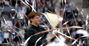 Italy's Jannik Sinner celebrates with his trophy after winning the 2026 ATP Tour Madrid Open tennis tournament final singles match against Germany's Alexander Zverev at the Caja Magica, Madrid, Spain, May 3, 2026. (AFP Photo)