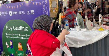 Female vendors stand at their stalls displaying colorful goods as visitors browse and shop, Istanbul, Türkiye, Dec. 19, 2025. (Shutterstock Photo)