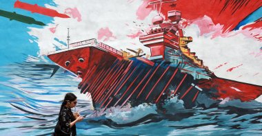 An Iranian walks next to an anti-U.S. mural in a street in Tehran, Iran, May 4, 2026. (EPA Photo)