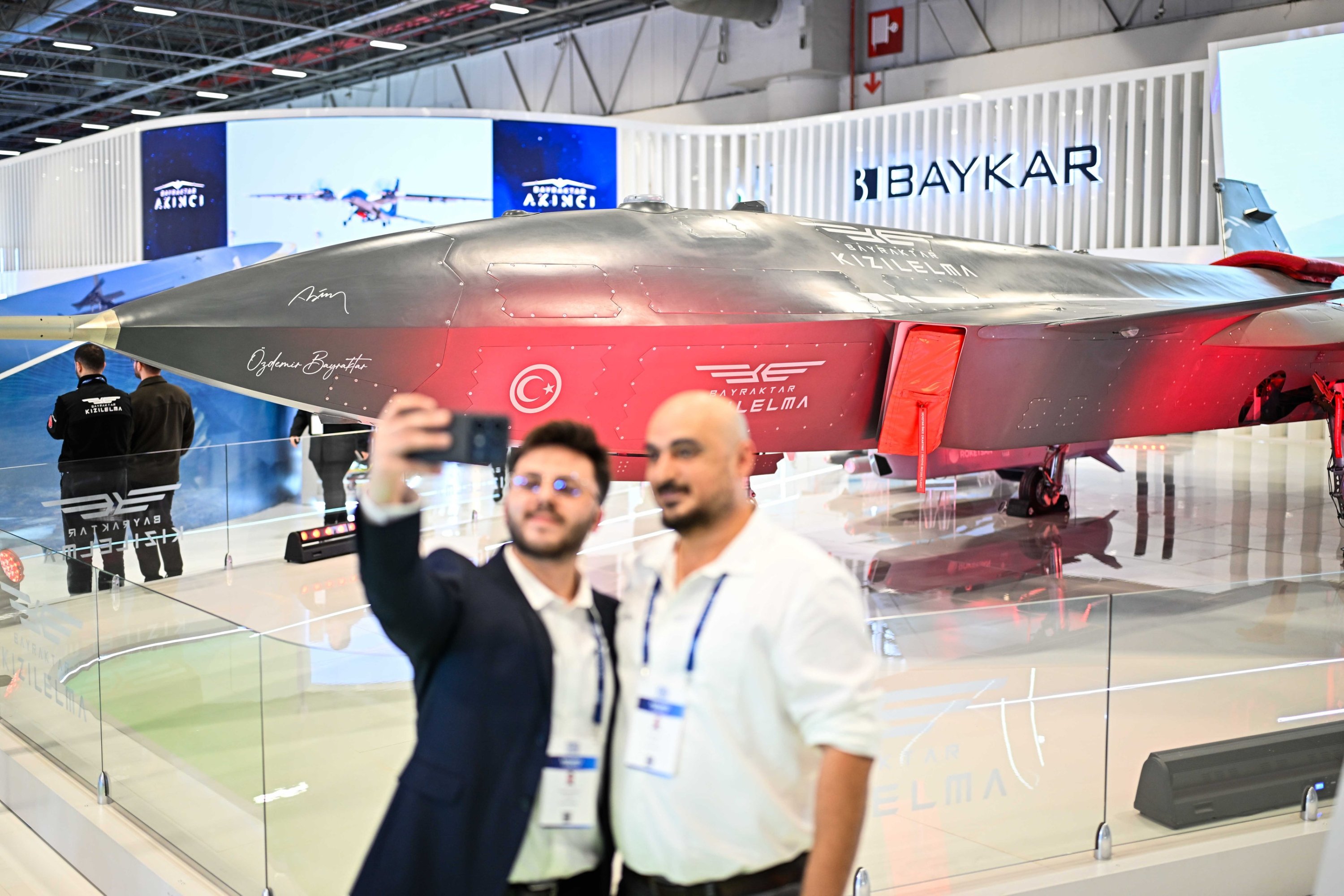 People take a photo close to the Kızılelma fighter jet developed by Turkish defense giant Baykar during the SAHA 2026 defense fair, Istanbul, Türkiye, May 5, 2026. (AA Photo)