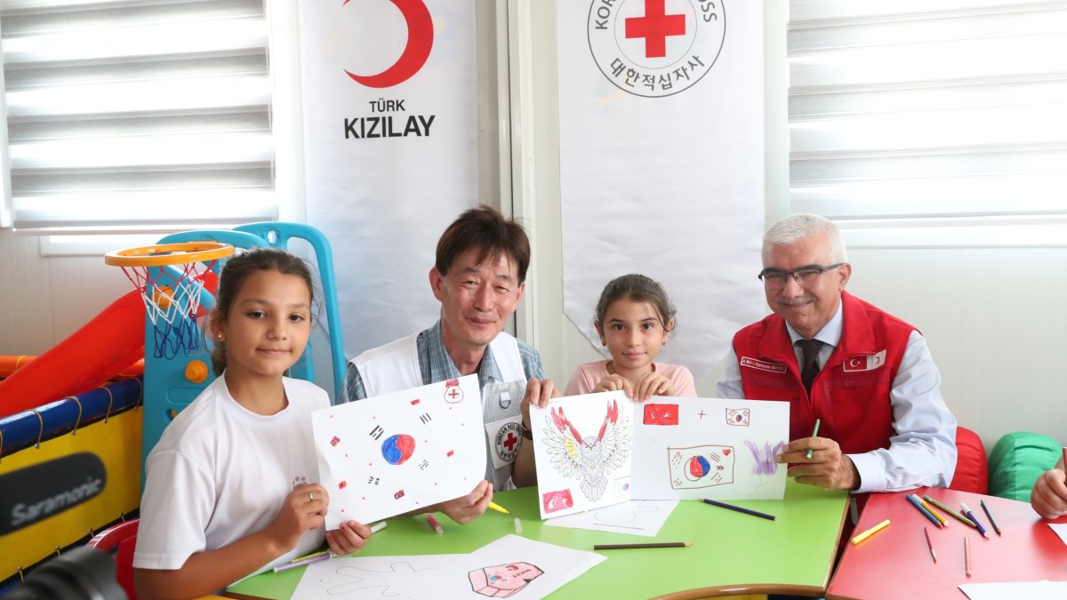 Officials from the Turkish Red Crescent (Kızılay) and the Korean Red Cross pose with children after signing a joint humanitarian cooperation agreement, Ankara, Türkiye, May 5, 2026. (Courtesy of Kızılay)