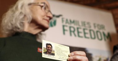 Debra Tice, the mother of American journalist Austin Tice, who went missing in Syria in 2012, holds a card with a picture of her son during a press conference, Damascus, Syria, Jan. 20, 2025. (AP File Photo)