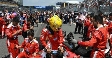 Ferrari's British driver Lewis Hamilton gets into his car at the starting grid before the start of the 2026 Miami Formula One Sprint at Miami International Autodrome, Miami Gardens, May 2, 2026. (AFP Photo)