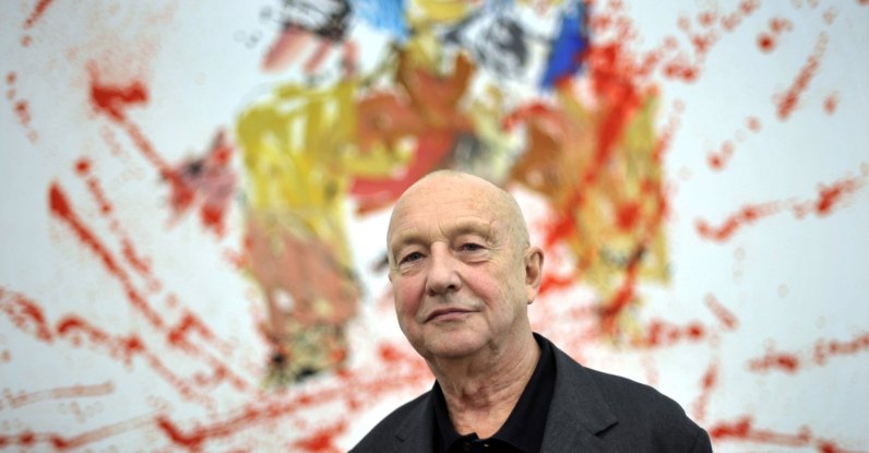German artist Georg Baselitz poses in front of his painting "Modern Painter (remix)" during an exhibition of his work in Baden, the southern German city of Baden, Germany, Nov. 19, 2009. (Getty Images Photo)