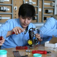 A vocational high school student works on a robot designed with classmates at a school workshop ahead of the 18th International MEB Robot Competition, Muş, Türkiye, May 4, 2026. (AA Photo)