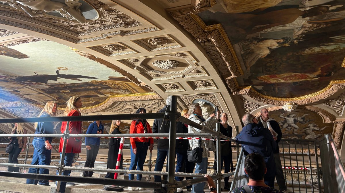 People look at a restored painting of Gustav Klimt during a guided tour of the restoration of the ceiling paintings at the Burgtheater, Vienna, Austria, April 20, 2026. (AP Photo)