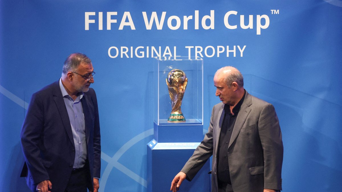 President of Iran Football Federation Mehdi Taj and Mayor of Tehran Alireza Zakani stand next to the FIFA World Cup Trophy during an unveiling ceremony, Tehran, Iran, Sept. 1, 2022. (Reuters Photo)