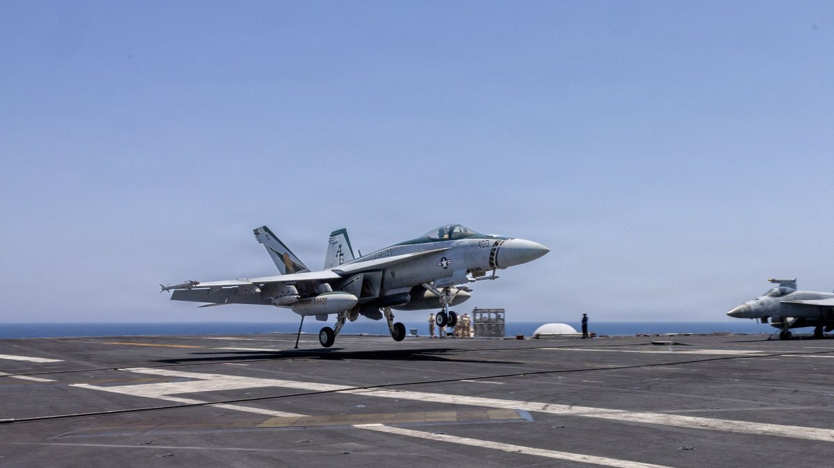 This U.S. Navy handout photo released on May 6, 2026 by U.S. Central Command Public Affairs, shows an F/A-18E Super Hornet landing aboard Nimitz-class aircraft carrier USS George H.W. Bush (CVN 77) at sea on April 27, 2026. (AFP via CENTCOM)