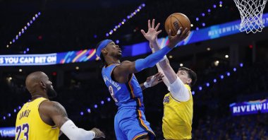Oklahoma City Thunder's Shai Gilgeous-Alexander (C) goes up for a basket as Los Angeles Lakers' Jake LaRavia (R) defends in the second half during game one of the second round of the 2026 NBA Playoffs at Paycom Center, Oklahoma City, U.S., May 5, 2026. (Reuters Photo)
