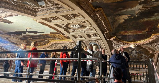 People look at a restored painting of Gustav Klimt during a guided tour of the restoration of the ceiling paintings at the Burgtheater, Vienna, Austria, April 20, 2026. (AP Photo)