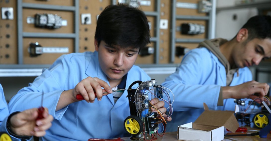A vocational high school student works on a robot designed with classmates at a school workshop ahead of the 18th International MEB Robot Competition, Muş, Türkiye, May 4, 2026. (AA Photo)