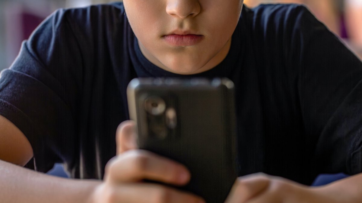 A boy uses a mobile phone amid growing concerns over digital addiction among children. (Shutterstock Photo)