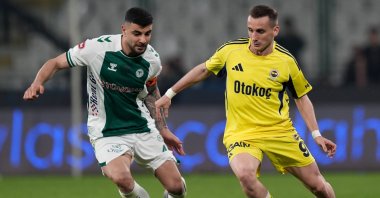 Fenerbahçe's Kerem Aktürkoğlu (R) and Konyaspor's Adil Demirbağ battle for the ball during the Ziraat Turkish Cup quarterfinal match at Medaş Konya Metropolitan Stadium, Konya, Türkiye, April 21, 2026. (AA Photo)
