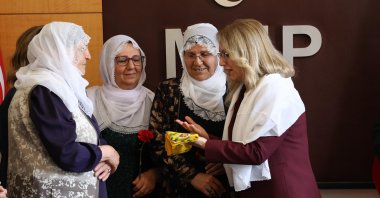 MHP's Filiz Kılıç (R) presents scarves as a gift to the Peace Mothers, Ankara, Türkiye, May 7, 2026. (DHA Photo)