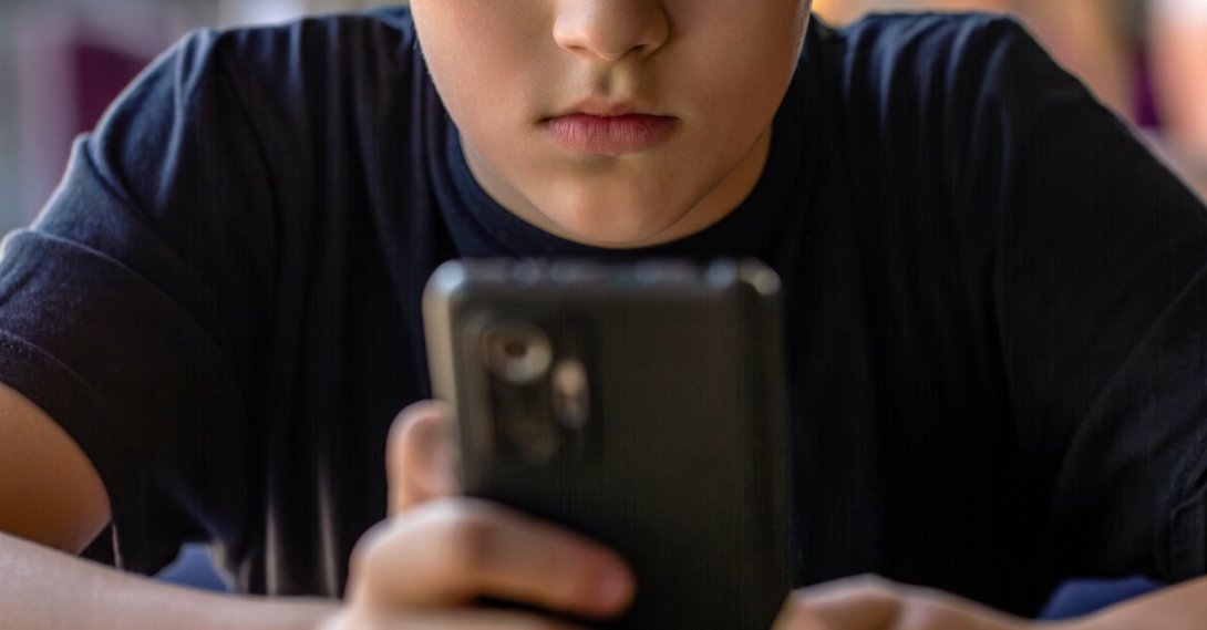 A boy uses a mobile phone amid growing concerns over digital addiction among children. (Shutterstock Photo)