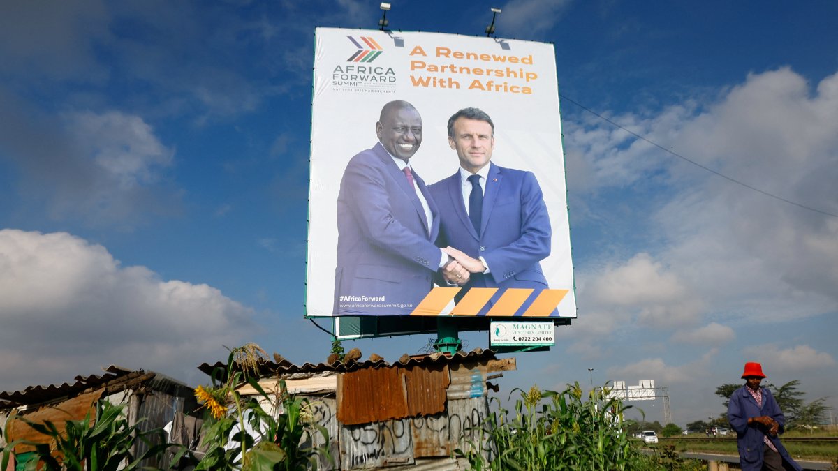 A pedestrian walks near a billboard featuring Kenyan President William Ruto and French President Emmanuel Macron ahead of the "Africa Forward" Summit, Nairobi, Kenya, May 7, 2026. (Reuters Photo)