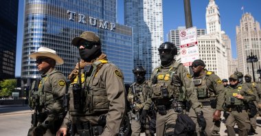Federal agents from U.S. Immigration and Customs Enforcement and U.S. Customs and Border Protection walk along West Wacker Drive in the Loop, Chicago, U.S., Sept. 28, 2025. (AP Photo)