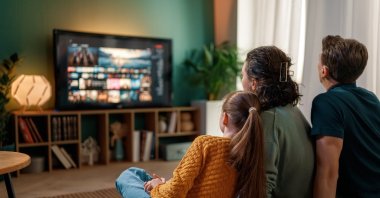 A family watches a television drama together at home as Turkish TV series continue to expand their global cultural influence. (Shutterstock Photo) 