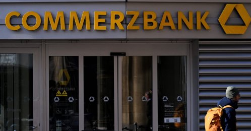 A pedestrian walks past the Commerzbank building with the bank's logo in the banking district skyline in Frankfurt am Main, western Germany, Nov. 6, 2025. (AFP Photo)