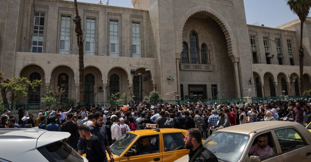 People gather outside the Palace of Justice, on the day of a trial session of Atef Najib, a brigadier general and former head of the Political Security Department in Daraa during Syria's ousted dictator Bashar Assad's rule, in Damascus, Syria, April 26, 2026. (Reuters Photo)