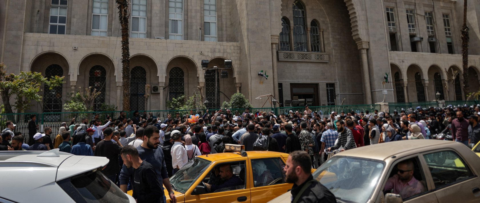 People gather outside the Palace of Justice, on the day of a trial session of Atef Najib, a brigadier general and former head of the Political Security Department in Daraa during Syria's ousted dictator Bashar Assad's rule, in Damascus, Syria, April 26, 2026. (Reuters Photo)