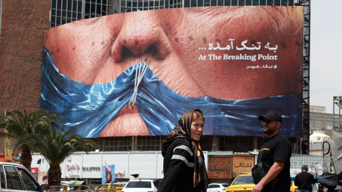 Iranians walk past a huge anti-U.S. billboard featuring U.S. President Donald Trump and the Strait of Hormuz at Valiasr Square, Tehran, Iran, May 2, 2026. (EPA Photo)