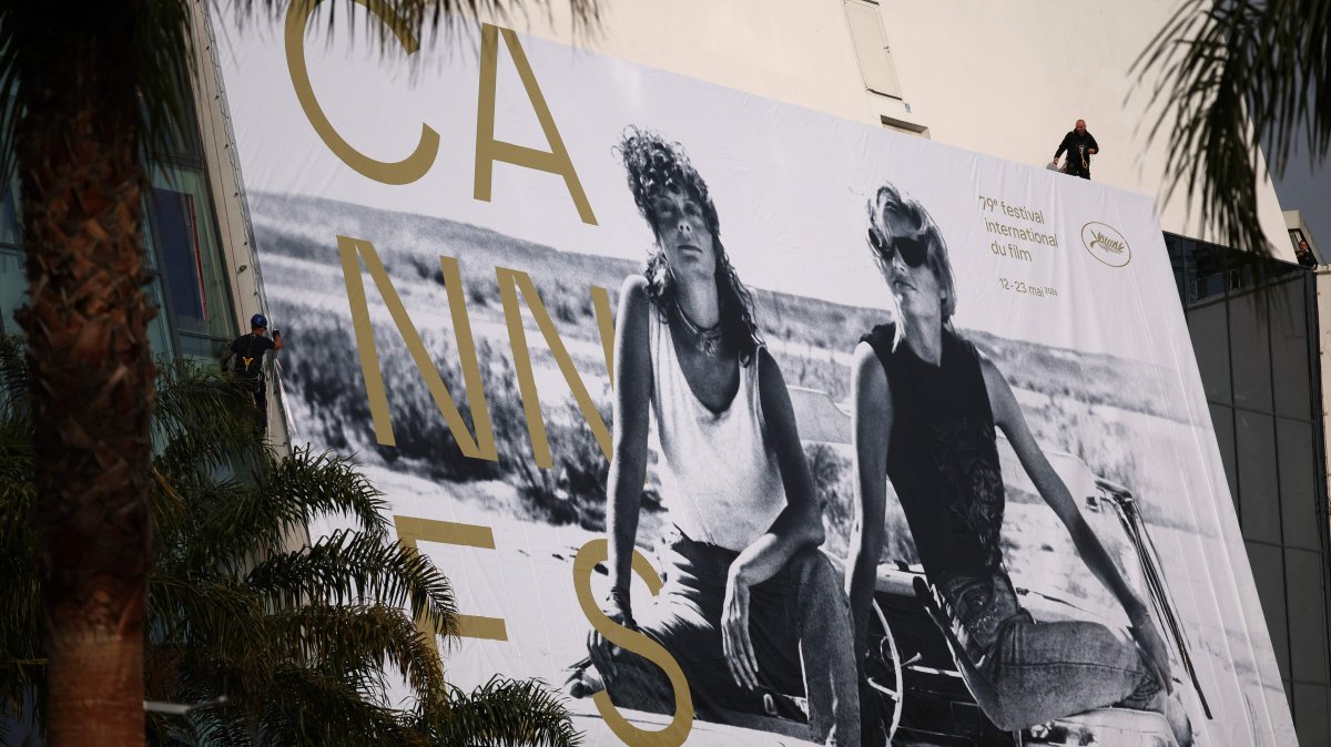 Workers hang the official poster of the 78th Cannes Film Festival on the facade of the Palais des Festivals, Cannes, France, May 10, 2026. (AFP Photo)