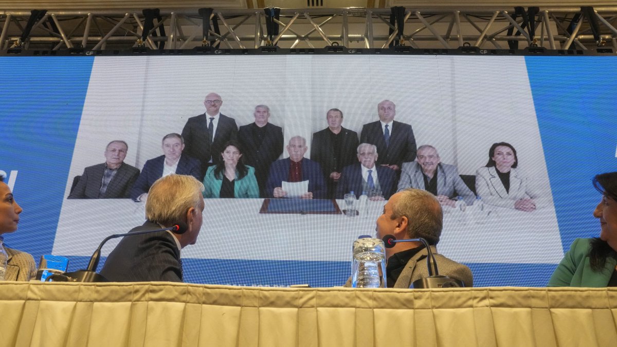 DEM Party members attend a news conference against the backdrop of a photo of PKK's jailed leader Abdullah Öcalan (C), Istanbul, Türkiye, Feb, 27, 2025. (AP Photo)