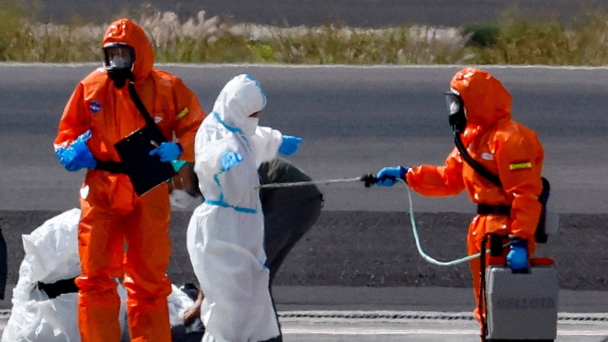 A passenger of the cruise ship MV Hondius, which was affected by a hantavirus outbreak, gets disinfected on the tarmac at Tenerife Sud airport, Canary Islands, Spain, May 10, 2026. (Rueters Photo)