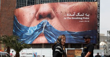 Iranians walk past a huge anti-U.S. billboard featuring U.S. President Donald Trump and the Strait of Hormuz at Valiasr Square, Tehran, Iran, May 2, 2026. (EPA Photo)