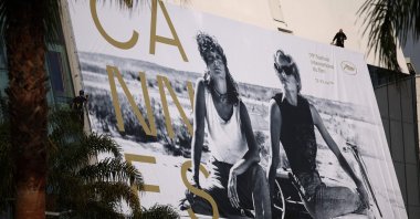 Workers hang the official poster of the 78th Cannes Film Festival on the facade of the Palais des Festivals, Cannes, France, May 10, 2026. (AFP Photo)