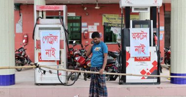 Mohammad Yusuf, a farmer, speaks on his phone as he arrives at a fuel station to buy diesel to irrigate his paddy field, but finds none available amid a fuel crisis, in Manikganj, Bangladesh, April 8, 2026. (Reuters Photo)