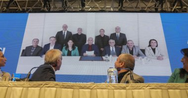 DEM Party members attend a news conference against the backdrop of a photo of PKK's jailed leader Abdullah Öcalan (C), Istanbul, Türkiye, Feb, 27, 2025. (AP Photo)